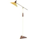 1950s Italian floor lamp with a teak triangular base long brass rod and conical yellow lampshade