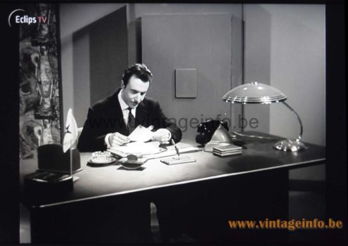 Helo Leuchten Desk Lamp – Het Geluk Komt Morgen (1958) Film Helo Leuchten Desk Lamp used as a set decoration in the film Het Geluk Komt Morgen (1958)