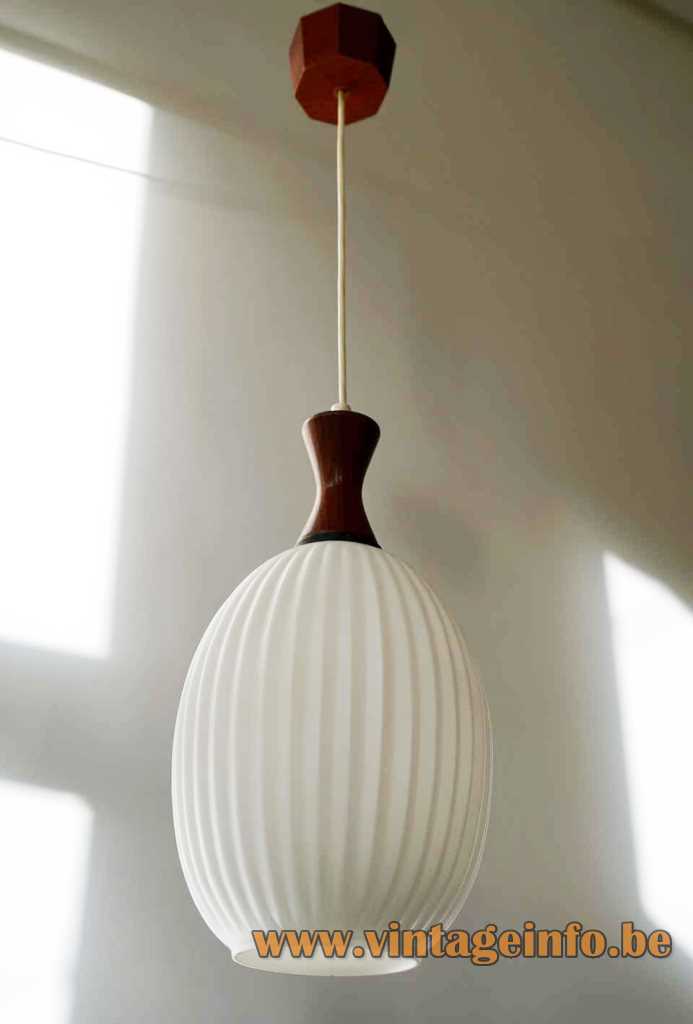 Massive ribbed glass pendant lamp Louis Kalff opal oval lampshade concave dark wood top 1960s Belgium