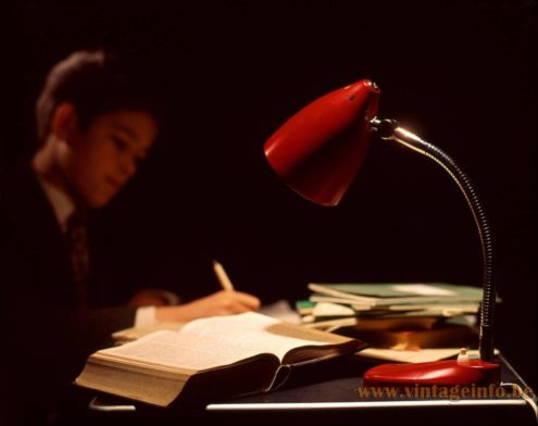 Hala Zeist desk lamp 13 1975 photo - A boy does his homework by the light of a red Hala desk lamp.