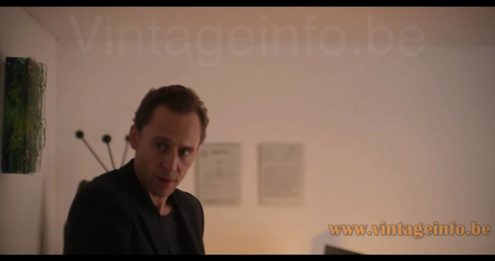 Raak Chartres blue-green glass wall lamp used as a set decoration in the 2026 British spy thriller television serial The Night Manager 